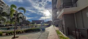 a palm tree on a sidewalk next to a building at Apartamento en Peña Azul "La Aldea" Ricaurte, Cundinamarca in Ricaurte