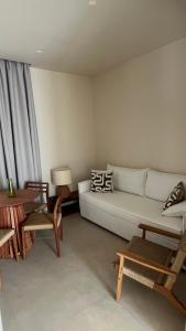 a living room with a white couch and a table at MIRA MARE - Apartment 5 in Stavros