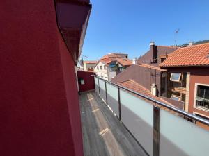 a view of a balcony from a red building at Ático en pleno centro en Cangas in Cangas de Morrazo