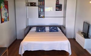 a small bedroom with a bed and a television at Terrazza Tosti in Formia