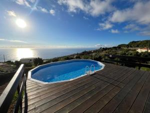 a swimming pool on a deck with the ocean in the background at Villa Las Flores - Piscina privada - Private pool - by Rural La Palma in Tijarafe +17 photos