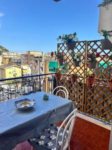 a blue table and chairs on a balcony at Chicca House in Maiori