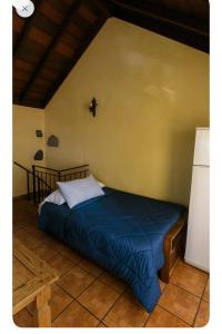a bedroom with a bed in the corner of a room at Villa Las Flores - Piscina privada - Private pool - by Rural La Palma in Tijarafe