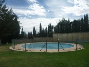 a swimming pool in a yard with trees in the background at Hostal Castilla in Serón de Nájima