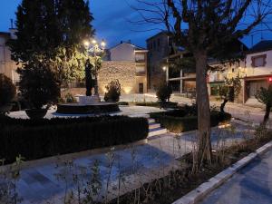 a statue in the middle of a courtyard at night at Hostal Castilla in Serón de Nájima