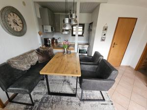 a living room with a couch and a wooden table at Boddenhaus Stahlbrode in Reinberg