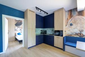 a kitchen with blue walls and a seafood mural on the wall at Prime - Event & Relax Resort in Jaszczurowa