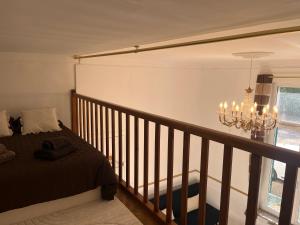 a bedroom with a bed and a chandelier at Le Cantilien Apartment - Chantilly in Chantilly