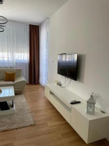 a living room with a flat screen tv on a wall at Bagdala apartman Krusevac in Kruševac