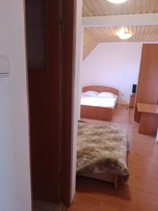 a bedroom with a bed in a room with a doorway at Casa Daniela in Horezu +10 photos