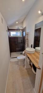 a bathroom with a toilet and a glass shower at La Casita in Avignon