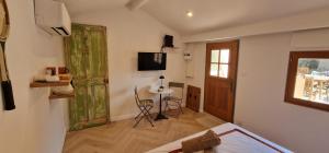 a room with a bed and a table and a window at La Casita in Avignon