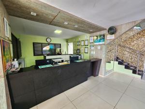 an office with a reception desk and a staircase at Guarany Hotel Express in João Pessoa