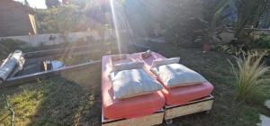 a bed with two pillows on it in a yard at La Casita in Avignon