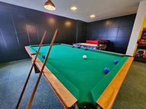 a snooker room with a green pool table at Guarany Hotel Express in João Pessoa
