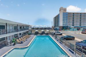 a pool on top of a building with a parking lot at The Beach House in Wildwood