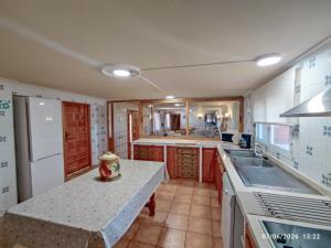 a kitchen with a sink and a counter top at VILLA CERRO MORENOVilla privada con piscina en finca exclusiva a 10 min de Lagunas de Ruidera in Ossa de Montiel