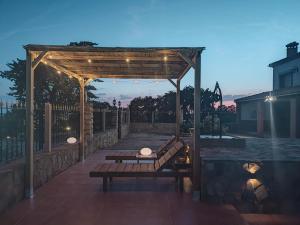 a wooden pergola with a bench on a patio at VILLA CERRO MORENOVilla privada con piscina en finca exclusiva a 10 min de Lagunas de Ruidera in Ossa de Montiel