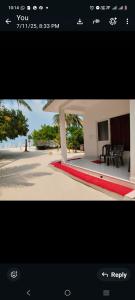 a picture of a house with a red carpet at PP Beach Villa in Agatti +4 photos
