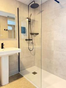 a shower with a glass door next to a sink at STAR BAY Hotel in Calafell +31 photos