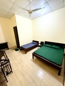 a room with two beds in a room at SSF Green Home in Akkaraipattu