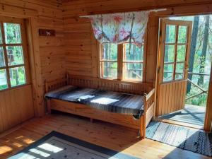 ein Zimmer in einer Blockhütte mit Fenstern in der Unterkunft Forest lodge in Lohja + 5 Fotos