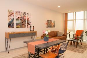 a living room with a table and a couch at ZİN D Home Dudullu Suit Otel in Istanbul