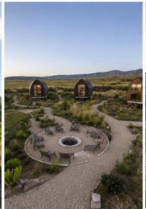 a group of tents in a field with a fire pit at Sauron Adventure Bungaloft in Villa Carlos Paz
