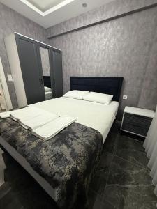 a bedroom with a large bed with white sheets at Denizli - Akcakoca Suite in Zeytinkoy +19 photos