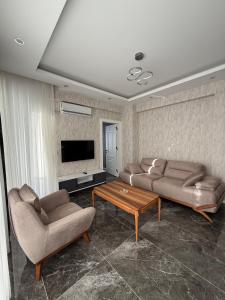 a living room with two couches and a coffee table at Denizli - Akcakoca Suite in Zeytinkoy