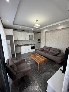 a living room with two couches and a coffee table at Denizli - Akcakoca Suite in Zeytinkoy