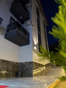 a building with a balcony at night at Denizli - Akcakoca Suite in Zeytinkoy