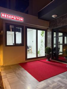 a lobby with a red rug in front of a building at Denizli - Akcakoca Suite in Zeytinkoy