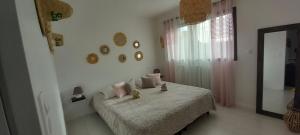 a bedroom with a bed with two teddy bears on it at Chambres D'Hotes Chez Sylvie in Cancale +2 photos
