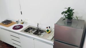 a small kitchen with a sink and a refrigerator at Cosy Open Space Apartment Bari in Bari +19 photos