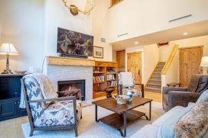 a living room with a fireplace and a staircase at Elkhorn View Retreat in Sun Valley