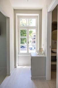 a white room with a window and a table at Nama Suites in Skopelos Town