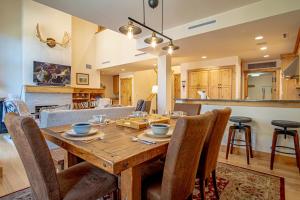 a dining room and living room with a wooden table and chairs at Elkhorn View Retreat in Sun Valley