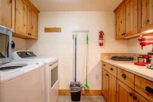 a kitchen with a washer and dryer and a sink at Elkhorn View Retreat in Sun Valley +53 photos