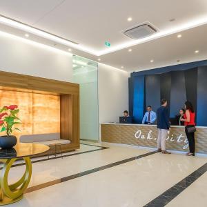 a group of people standing at a counter in a lobby at Panorama Central Batumi in Batumi
