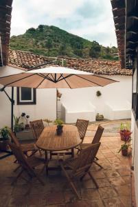 a table and chairs with an umbrella on a patio at Casa Rural El Palmar in Vallehermoso