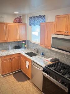 a kitchen with wooden cabinets and a sink and a stove at Providence & 18th in Chester