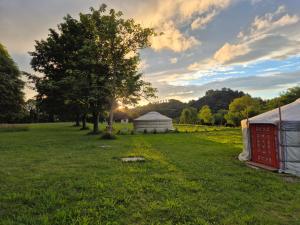 a marquee and a yurt in a field at Les Cabanes d Erhes in Saint-Pé-de-Bigorre