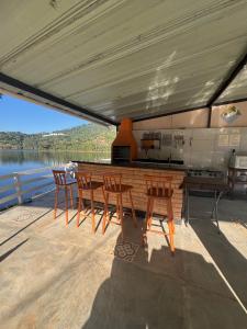 a table and chairs on the deck of a boat at Chalés Talismã in Caconde