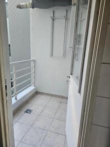 a bathroom with a door and a tiled floor at Palermo Apart 2 in Buenos Aires +14 photos