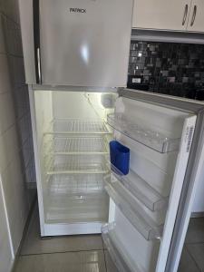 an empty refrigerator with its door open in a kitchen at Palermo Apart 2 in Buenos Aires