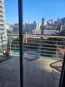 a patio with a table and chairs on a balcony at Palermo Apart 2 in Buenos Aires