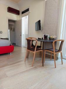 a living room with a table and chairs and a bed at Palazzo Lanzilao's Rooms in Lecce
