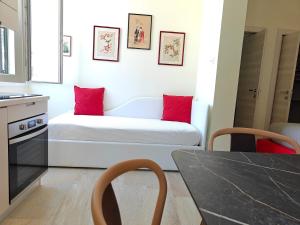 a room with a bed with red pillows on it at Palazzo Lanzilao's Rooms in Lecce