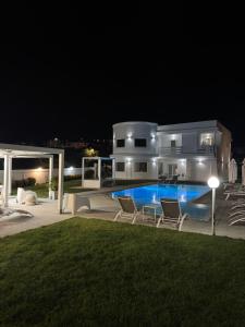 a house with a swimming pool at night at Al Mare da Francesca in Olbia